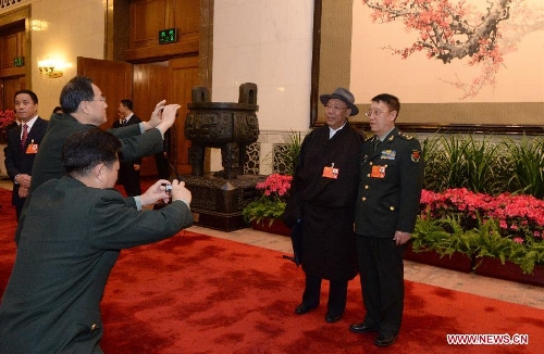 Deputies to the 12th National People's Congress (NPC) pose for a photo before the closing meeting of the first session of the 12th NPC at the Great Hall of the People in Beijing, capital of China, March 17, 2013.(Xinhua/Chen Shugen)  