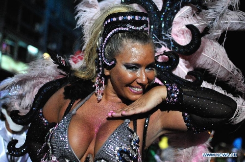 A dancer participates in the 2013 Carnival Inauguration Parade on the July 18 Avenue in Montevideo, capital of Uruguay, on Jan. 25, 2013. Various artists participate in the carnival, which attracts more than 100,000 people each year in the July 18 Avenue, according to the local press. (Xinhua/Nicolas Celaya) 