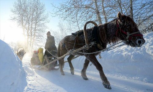 A herdsman of Kazak ethnic group controls a sledge dragged by a horse after snowfall in Altay, northwest China's Xinjiang Uygur Autonomous Region, Dec. 28, 2012. Beautiful snow scenery here attracts a good many tourists. Photo: Xinhua