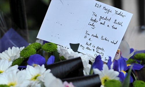 A written tribute and flowers are pictured outside the home of former British prime minister Margaret Thatcher in central London following her death earlier Monday. Thatcher, the 