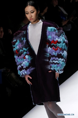 A model presents a creation designed by students from China Academy of Art during the 1st China Graduate Fashion Week in Beijing, capital of China, April 24, 2013. A total of 610 graduate students from 22 universities will present their designs during the five-day event which kicked off on Wednesday. (Xinhua/Li Mingfang)