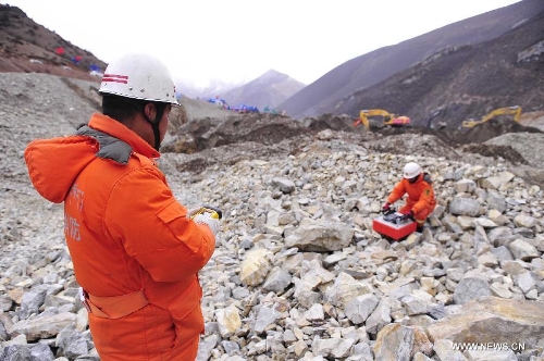 Rescuers work at the accident site in Maizhokunggar County of Lhasa, southwest China's Tibet Autonomous Region, March 31, 2013. Thirteen bodies have been found until 6:30 p.m. Sunday at the site of a mining area landslide. The disaster struck a workers' camp of the Jiama Copper Polymetallic Mine at about 6 a.m. on Friday, burying 83 workers. (Xinhua/Liu Kun)