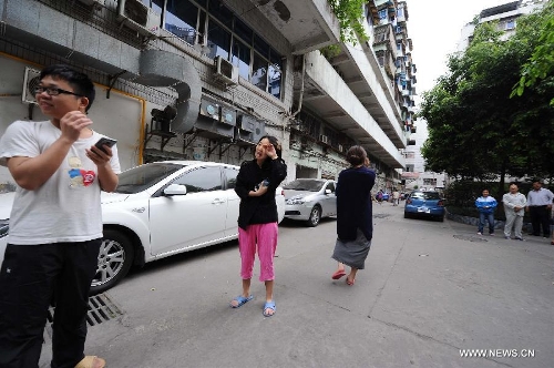 Citizens gather outside their apartments to avoid aftershocks of an earthquake, in Chongqing, adjacent to southwest China's Sichuan Province, April 20, 2013. A 7.0-magnitude earthquake hit Lushan County of Sichuan Province at 8:02 a.m. Beijing Time (0002 GMT) on Saturday, according to the China Earthquake Networks Center (CENC). The epicenter, with a depth of 13 kilometers, was monitored at 30.3 degrees north latitude and 103.0 degrees east longitude. Residents in Chongqing felt the earthquake. (Xinhua/Li Jian)