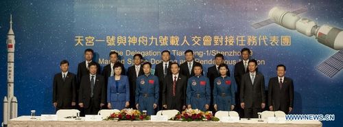 Some members of the Delegation of Tiangong-1/Shenzhou-9 Manned Space Docking and Rendezvous Mission pose for a group photo at a press conference in South China's Hong Kong, August 10, 2012. A 40-plus-member delegation, including three astronauts who had fulfilled China's first manned space docking mission this June, arrived at Hong Kong Friday for a four-day visit. Photo: Xinhua
