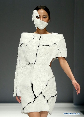 A model presents a creation designed by students from China Academy of Art during the 1st China Graduate Fashion Week in Beijing, capital of China, April 24, 2013. A total of 610 graduate students from 22 universities will present their designs during the five-day event which kicked off on Wednesday. (Xinhua/Chen Jianli)