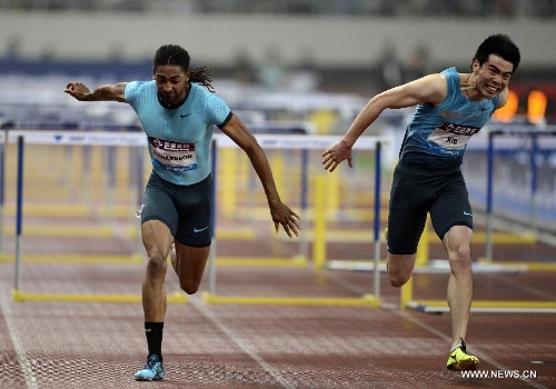 Jason Richardson (L) of the United States and Xie Wenjun of China compete during the men's 110m hurdles during the IAAF Diamond League Athletics meet in Shanghai, east China, May 18, 2013. Richardson won the first place of the event in 13.23 seconds. Xie Wenjun took the third place. (Xinhua/Li Jundong) 