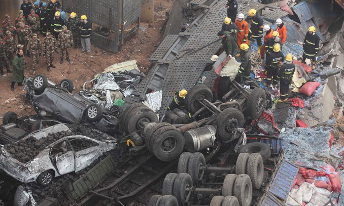 Rescuers work at the accident site where an 80-meter-long section of an expressway bridge collapsed due to a truck explosion in Mianchi County, Sanmenxia, central China's Henan Province, February1, 2013. At least 8 people died and 13 others injured after the explosion. The exploded truck was loaded with fireworks, according to an initial investigation. Search and rescue efforts are under way and traffic control was imposed on the expressway. Photo: Xinhua