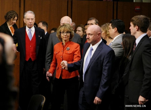 Former U.S. Rep. Gabby Giffords (front L) who is a shooting victim, accompanied with her husband Navy Capt. Mark Kelly (front R) arrives at the hearing for a Senate Judiciary Committee about gun control on Capitol Hill in Washington D.C., the United States, Jan. 30, 2013. (Xinhua/Fang Zhe) 
