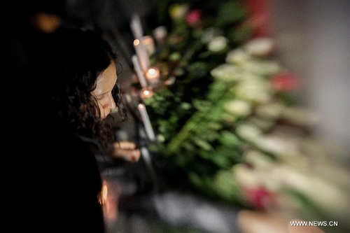 A resident reacts after the news of Venezuelan President Hugo Chavez's death was released, in Mexico City, capital of Mexico, on March 5, 2013. Venezuelan President Hugo Chavez died on March 5. (Xinhua/Pedro Mera)