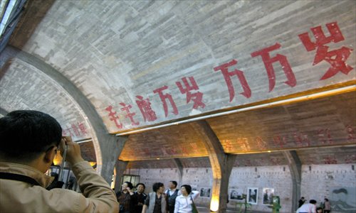 The 798 Art Zone bustles with tourists snapping photos of patriotic slogans (