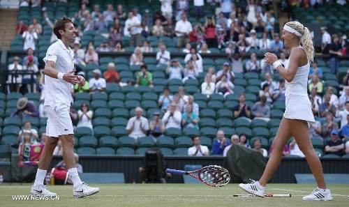 Daniel Nestor of Canada and Kristina Mladenovic (R) of France celebrate after the final of mixed doubles against Bruno Soares of Brazil and Lisa Raymond of the United States on day 13 of the Wimbledon Lawn Tennis Championships at the All England Lawn Tennis and Croquet Club in London, Britain, on July 7, 2013. Daniel Nestor and Kristina Mladenovic claimed the title with 2-1. (Xinhua/Wang Lili) 
