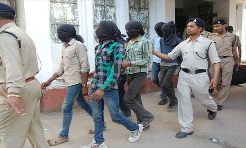 Indian policemen escort gang rape suspects to court in Datia, about 75 kilometers from Gwalior in the central Madhya Pradesh state, on Monday. Six men appeared in court Monday over the gang-rape and robbery of a Swiss cyclist holidaying in India, an assault which has rekindled alarm about the safety of tourists and rising sex crimes. Photo: AFP