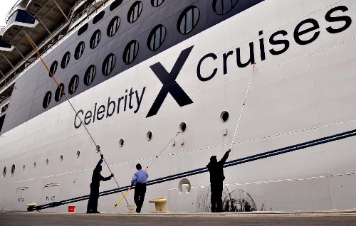 Crew members clean the cruise ship GTS Millennium at the Kai Tak Cruise Terminal in south China's Hong Kong, March 16, 2013. GTS Millennium arrived at Hong Kong's Kai Tak Cruise Terminal on Saturday and became the first cruise ship to berth at the terminal prior to its official opening in June 2013. (Xinhua/Chen Xiaowei)  