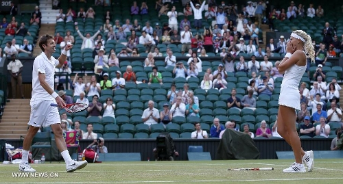 Daniel Nestor of Canada and Kristina Mladenovic (R) of France celebrate after the final of mixed doubles against Bruno Soares of Brazil and Lisa Raymond of the United States on day 13 of the Wimbledon Lawn Tennis Championships at the All England Lawn Tennis and Croquet Club in London, Britain, on July 7, 2013. Daniel Nestor and Kristina Mladenovic claimed the title with 2-1. (Xinhua/Wang Lili) 