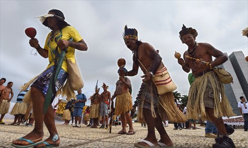 Brazilians from different ethnic groups dance in protest in front of Planalto Palace on Tuesday. 
Photos: AFP 