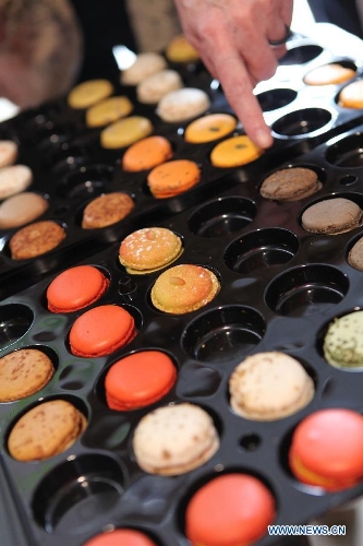Photo taken on Jan. 30, 2013 shows macarons displayed at the International Hospitality and Food Service Fair (SIRHA) in Lyon, France. The five-day fair was closed on Wednesday. The biyearly SIRHA was founded in 1984 and is considered one of the most influential food expos in Europe. (Xinhua/Gao Jing)