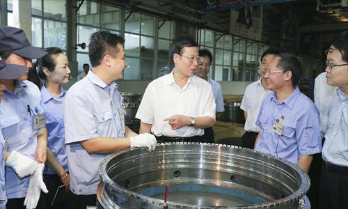 Chinese Vice Premier Zhang Gaoli (C) visits the China Aviation Industry Chengdu Engine (Group) Co., Ltd. in Chengdu, capital of southwest China's Sichuan Province, July 5, 2013. Zhang made a research tour in Sichuan from July 5 to July 8.  Photo: Xinhua
