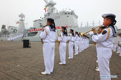 Officers and soldiers of Chinese navy take part in a ceremony for the departure of a fleet in the port of Qingdao, east China's Shandong Province, July 1, 2013. A Chinese fleet consisting of seven naval vessels departed from east China's harbor city of Qingdao on Monday to participate in Sino-Russian joint naval drills scheduled for July 5 to 12. The eight-day maneuvers will focus on joint maritime air defense, joint escorts and marine search and rescue operations. (Xinhua/Zha Chunming)