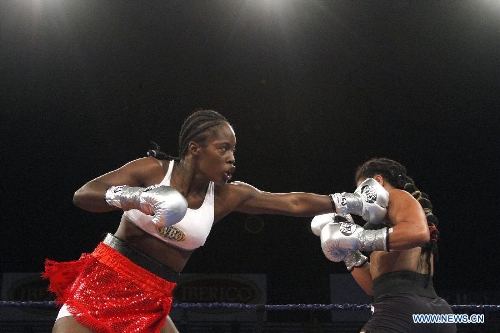  Oxandia Castillo (L) of Dominican Republic fights with Hanna Gabriels of Costa Rica during their WBO super welterweight boxing title fight in San Jose, capital of Costa Rica, on Feb. 28, 2013. (Xinhua/Kent Gilbert) (kg)  