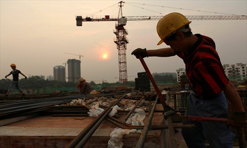 Workers start their shifts early Wednesday at a construction site in Chongqing. Due to high temperatures in the city, outdoor shifts at local construction sites have been starting at 5 am in the morning and 5 pm in the afternoon. The Chongqing meteorological bureau again issued an orange heat alert Wednesday, indicating temperatures above 37 C. Photo: CFP