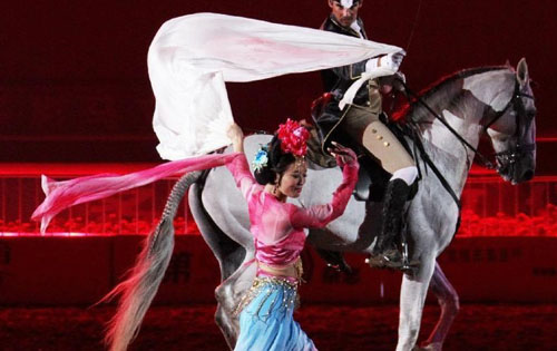 A horseman stages an equestrian performance at the opening ceremony of the second Ordos Dalate International Horse Culture Festival in Dalate Banner of Ordos, north China's Inner Mongolia Autonomous Region, August 25, 2012. Some 60 horsemen from 15 countries and regions gave performances at the festival's opening ceremony Saturday night. Photo: Xinhua