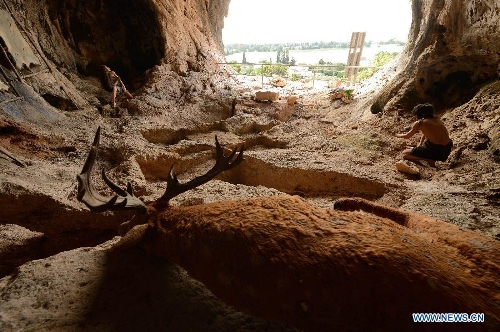 picture taken on May 19, 2013, shows a reconstructed habitation of the Mousterian culture (about 100,000 to 40,000 B.C.) in Jamal Cave on the western slopes of the Mount Carmel range near Israeli northern city of Haifa. Sites of human evolution at Mount Carmel, including the caves of Tabun, Jamal, el-Wad and Skhul, were recognized as World Heritage Site by United Nations Educational, Scientific and Cultural Organization in 2012. (Xinhua/Yin Dongxun)