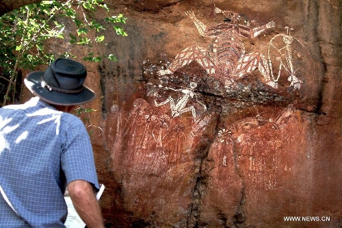 A tourist views the aboriginal rock paintings at the Kakadu National Park of Australia May 24, 2013. The Kakadu National Park is a protected area in the northern area of Australia. The cultural and natural values of the Kakadu National Park were recognized internationally when the park was inscribed onto the UNESCO World Heritage List. (Xinhua/Qian Jun)