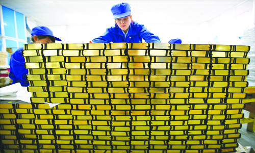 Two workers pile up Bibles at Nanjing Amity Printing Co in East China's Jiangsu Province Thursday. The company, the world's largest Bible printer, has printed more than 100 million copies since 1987 and exported them to more than 70 countries and regions. Photo: CFP 
