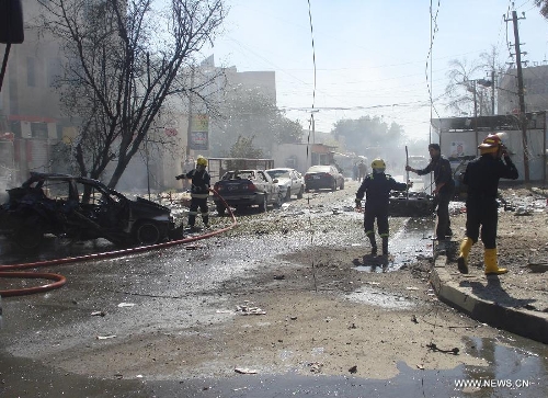 &nbsp;Iraqi firefighters work at the site of a car bomb attack at Karada district in Baghdad, Iraq, March 19, 2013. At least 48 people were killed and 167 others wounded in a series of bombings and shootings in the Iraqi capital of Baghdad on Tuesday, an Interior Ministry source said. (Xinhua/Bashar) 
