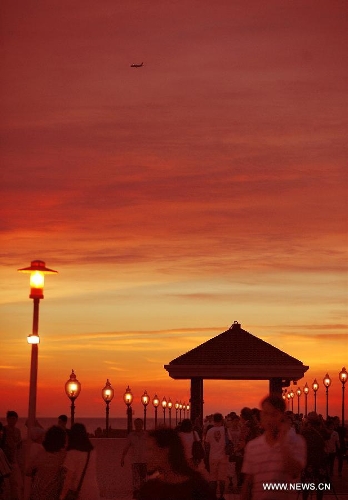 Tourists enjoy the sunset at the 