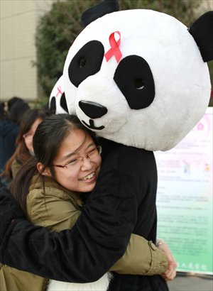 A girl hugs a college student dressed as an 