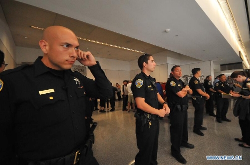 Policemen guard the room where passengers from the crash-landed Asiana Airlines flight rest in at San Francisco International Airport, the United States, July 6, 2013. The South Korean consulate has confirmed that the pair killed in a crash landing of an Asiana Airlines plane at San Francisco airport were women holding Chinese passports, the Chinese Consulate General in San Francisco told Xinhua Sunday. (Xinhua/Liu Yilin)