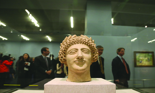 A limestone head of a youth wearing a wreath is displayed at the NMC in the exhibition Earth, Sea and Sky. 
Photo: CFP