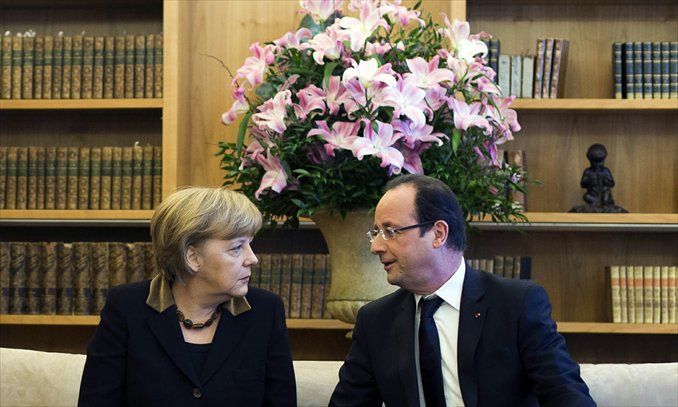 German Chancellor Angela Merkel (left) and French President Francois Hollande meet in Berlin on Tuesday as part of the celebration to mark 50 years since the Elysee Treaty. In signing the landmark treaty on January 22, 1963, then French president Charles de Gaulle and West German chancellor Konrad Adenauer sealed a new era of reconciliation between the former foes which has since driven European unity. Photo: AFP