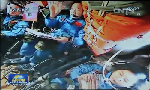 The three astronauts aboard Shenzhou-9 monitor the orbit change yesterday. The manned spacecraft is scheduled to dock with Tiangong-1 around 11 am after finishing its last orbit change around 5 am today. Photo: CFP