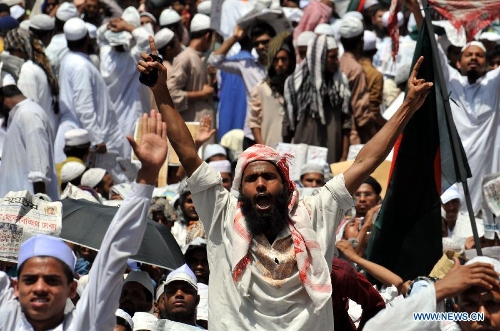 A Bangladeshi Muslim shouts slogans during a grand rally at Motijheel area in Dhaka, Bangladesh, April 6, 2013. Tens of thousands of Islamists under the banner of Hefazat-e-Islam from across Bangladesh poured into the key commercial hub of the capital city to join a grand rally, demanding action against the 