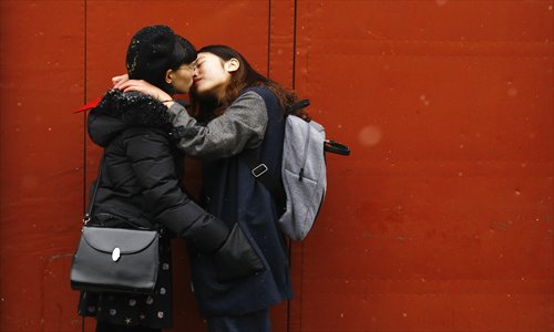 Ma Yuyu (left) and Elsie kiss in a small alley outside the marriage registration office where they asked to be married, before being denied, in Beijing on February 25, 2013. Photo: CFP