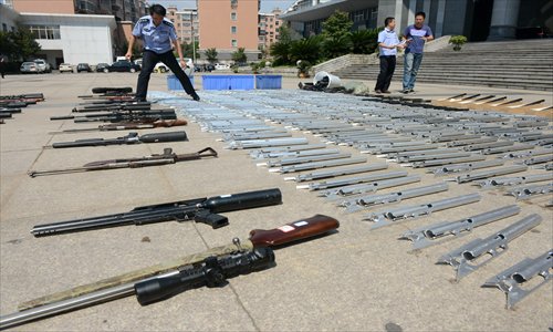 Local police in Pingxiang, Jiangxi Province, show the firearms they seized during their bust of online weapon sales. Photo: CFP