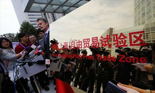 Ralph Haupter, corporate vice president of Microsoft, talks with reporters during a press conference after the inauguration of the China (Shanghai) Pilot Free Trade Zone during a ceremony in Pudong district of Shanghai on Sunday. Photo: AFP