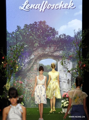 Models present creations by Austrian designer Lena Hoschek at the Spring/Summer 2014 Shows of the Mercedes-Benz Fashion Week, in Berlin, on July 2, 2013. (Xinhua/Pan Xu) 