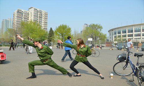 a foreign duo dressed as red guards mimic last year's viral