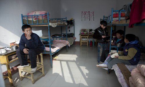 Boys rest in their dormitory. Photo: CFP