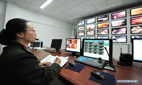 A staff member of Fuquan highway monitors the traffic situation in Fuzhou, capital of capital of southeast China's Fujian Province, Feb. 9, 2013. The highways in China will be toll-free for passenger cars from 0:00 on Feb. 9 to 24:00 on Feb. 15 when most Chinese will go home for the Spring Festival and return to work. Photo: Xinhua