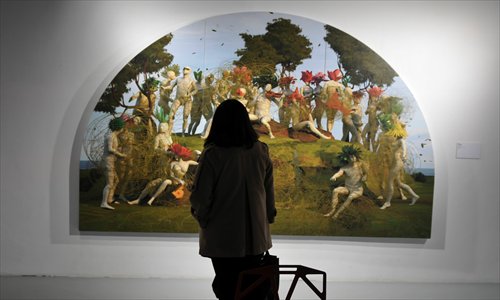 A woman pauses in front of a painting at an exhibition of contemporary art held in Chongqing this month. Photo: CFP
