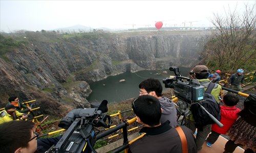 Media professionals gather at the construction site of the Sheshan 