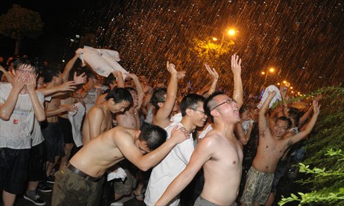 Students try to take over girls’ building in annual university water carnival

On Friday night, thousands of students who had just left a graduation party at the Huazhong University of Science and Technology in Wuhan, Hubei Province gathered in front of a dormitory building to continue celebrating at another non-official section of their party: water carnival. 
The festival started in 2006, when a freshman at the No.20 dormitory building poured water down on students passing by. Although the girl reportedly received some punishment from the university, the event evolved into an annual festival, which the university no longer interferes with.
Shouting, “take the No.20 building and grab the girls,” the boys tried to storm the building. The shrieking girls countered by pouring water from their balconies. The water reveling lasted until midnight before the crowds dispersed.
CFP

