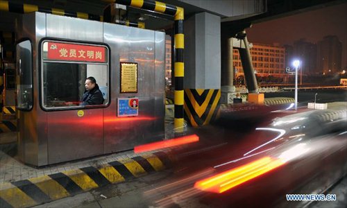 A car moves through a toll gate of highway in Changsha, capital of central China's Hunan Province, on Feb. 9, 2013. The highways in China will be toll-free for passenger cars from 0:00 on Feb. 9 to 24:00 on Feb. 15 when most Chinese will go home for the Spring Festival and return to work. Photo: Xinhua