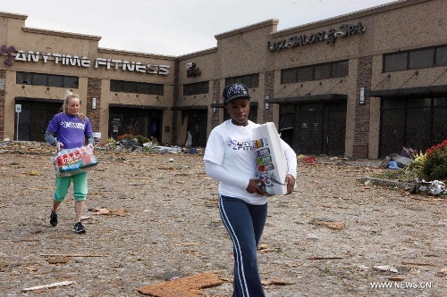 Residents begin cleanup of a destroyed fitness center in Moore, Oklahoma, May 21, 2013, one day after a tornado moved through the area. A powerful tornado attacked on Monday afternoon the southern suburbs of the Oklahoma City, capital of the U.S. state of Oklahoma, killing at least 24 people, including 9 children. (Xinhua/Song Qiong)