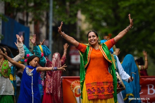 People participate in the annual Dance Parade in New York, on May 18, 2013. Over 200 dance groups showcasing 80 unique dance styles and cultures gathered from Broadway to the East Village on Saturday for the 7th Dance Parade in New York. (Xinhua/Niu Xiaolei) 