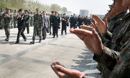 Soldiers and officers welcome Dempsey upon his visit to a Chinese army aviation base on April 24.